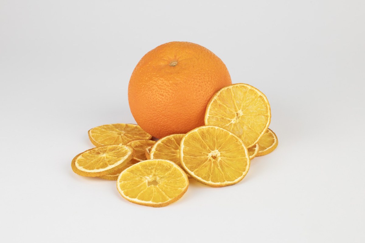 Fresh orange and dried slices, studio black background