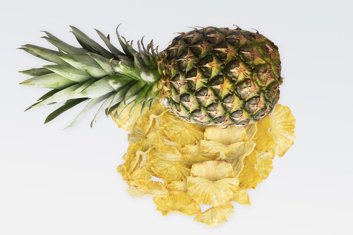 Fresh pineapple with dried slices, studio black background
