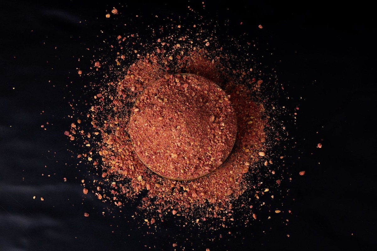 Coarse pomegranate granules in a wooden bowl