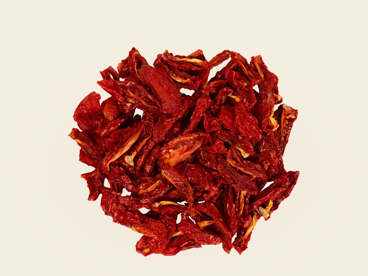 Dried tomato pieces on velvet background