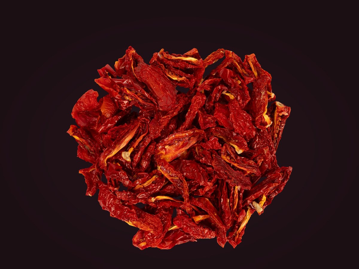 Dried tomato pieces on velvet background