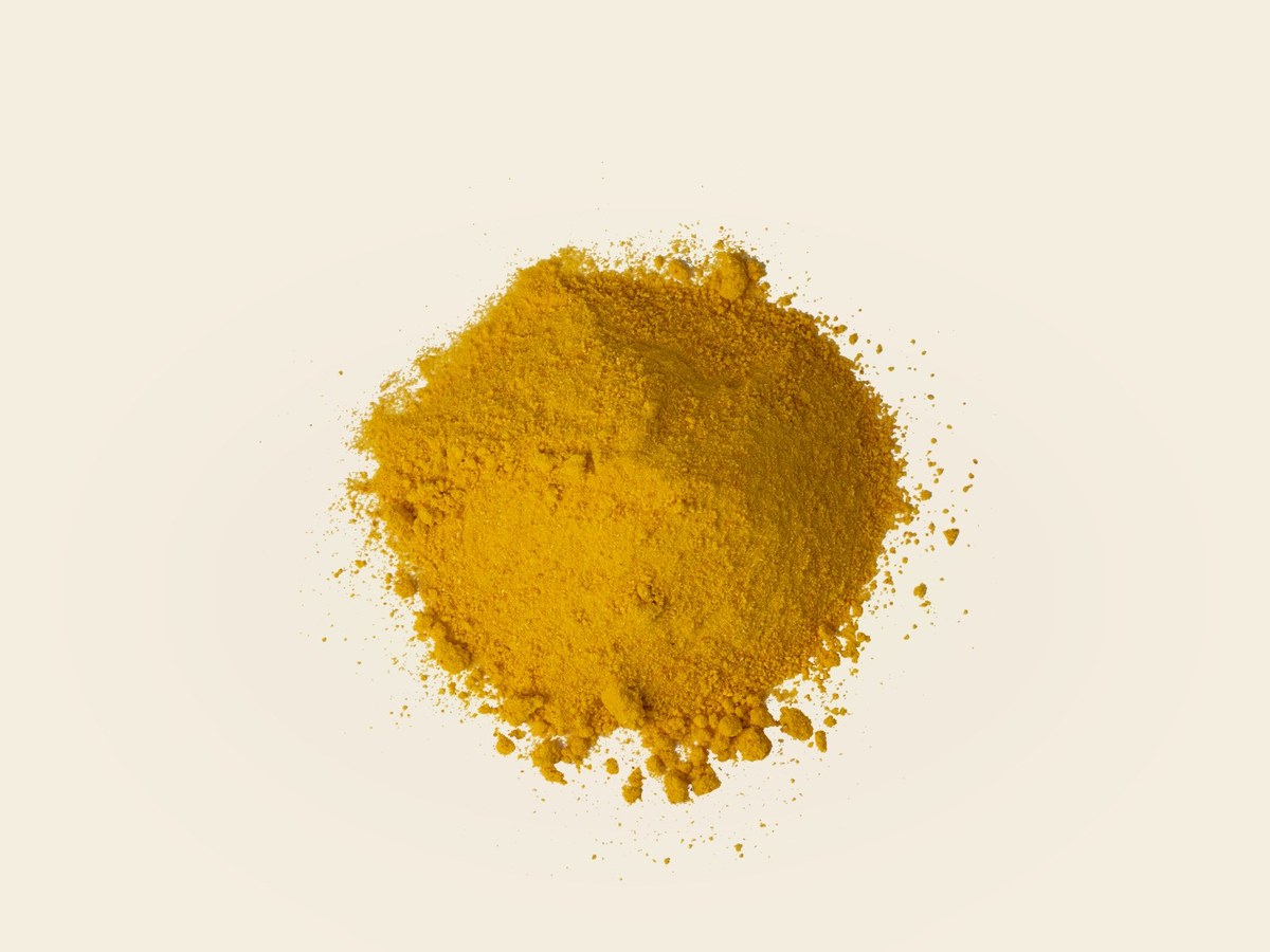 Golden mandarin powder in a wooden bowl