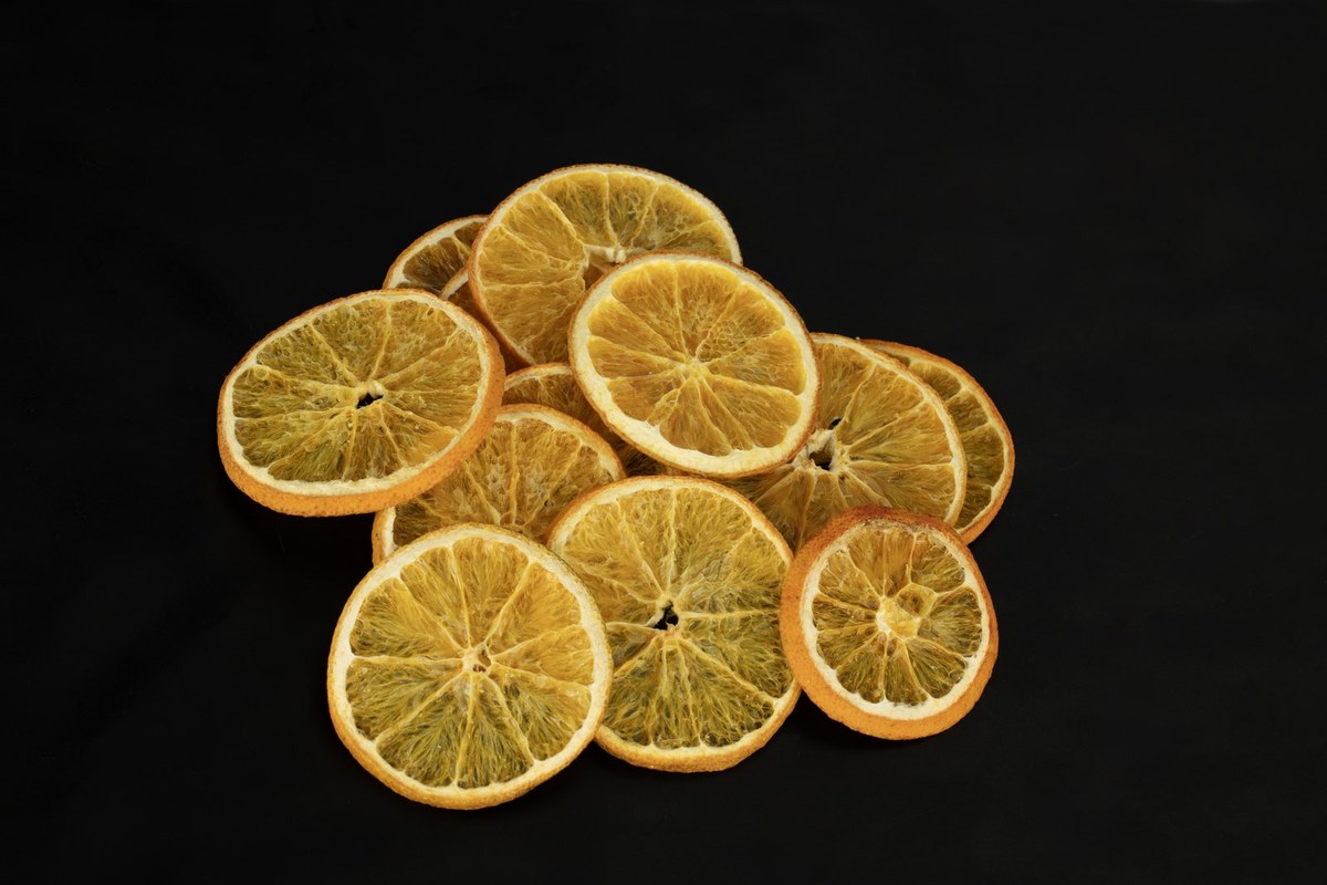 Fresh orange and dried slices, studio black background