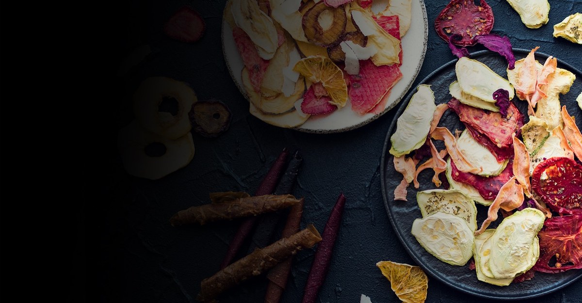 Dried fruits and vegetables on dark slate